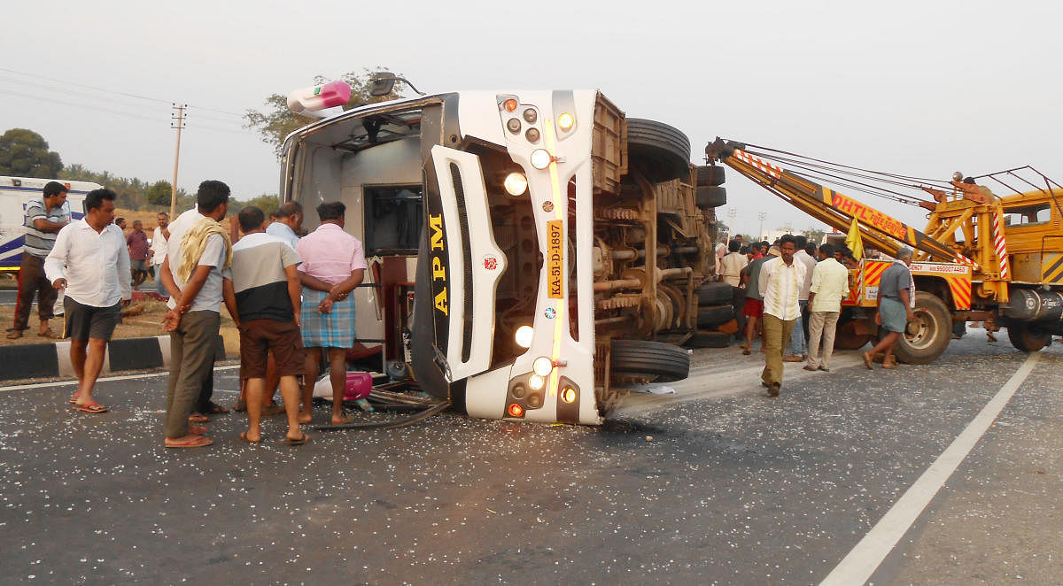 The bus that toppled at Hirisave in Hassan district, being removed to clear the road, on Friday.