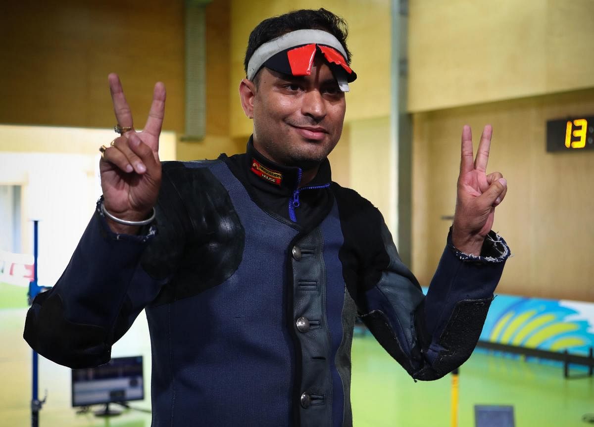 RECORD BREAKER India's Sanjeev Rajput flashes the victory sign after triumphing in the men's 50m rifle 3-position event on Saturday. AFP