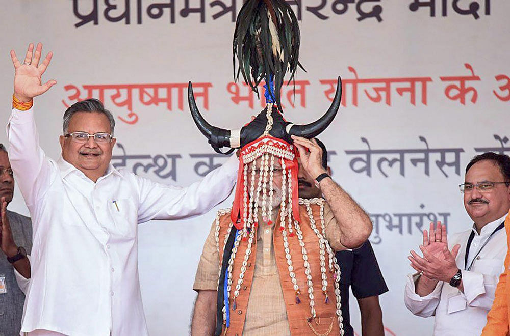 Narendra Modi being presented a traditional headgear during the inauguration of the Health and Wellness Centre to mark the launch of Ayushman Bharat, in Bijapur, Chhatisgarh on Saturday. PTI photo.