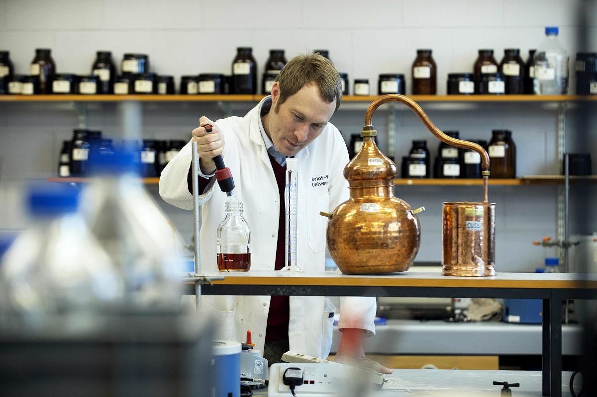 Assistant professor of distilling, Matthew Pauley (34) works at the International Centre for Brewing and Distilling which is based at Heriot-Watt University in Edinburgh, Scotland on February 28, 2018. Demand for more variety in Scotch whisky from fast-growing emerging markets and the request for lower alcohol varieties among health-conscious drinkers are challenging a closely guarded centuries-old tradition. (AFP PHOTO by Mark McLaughlin)