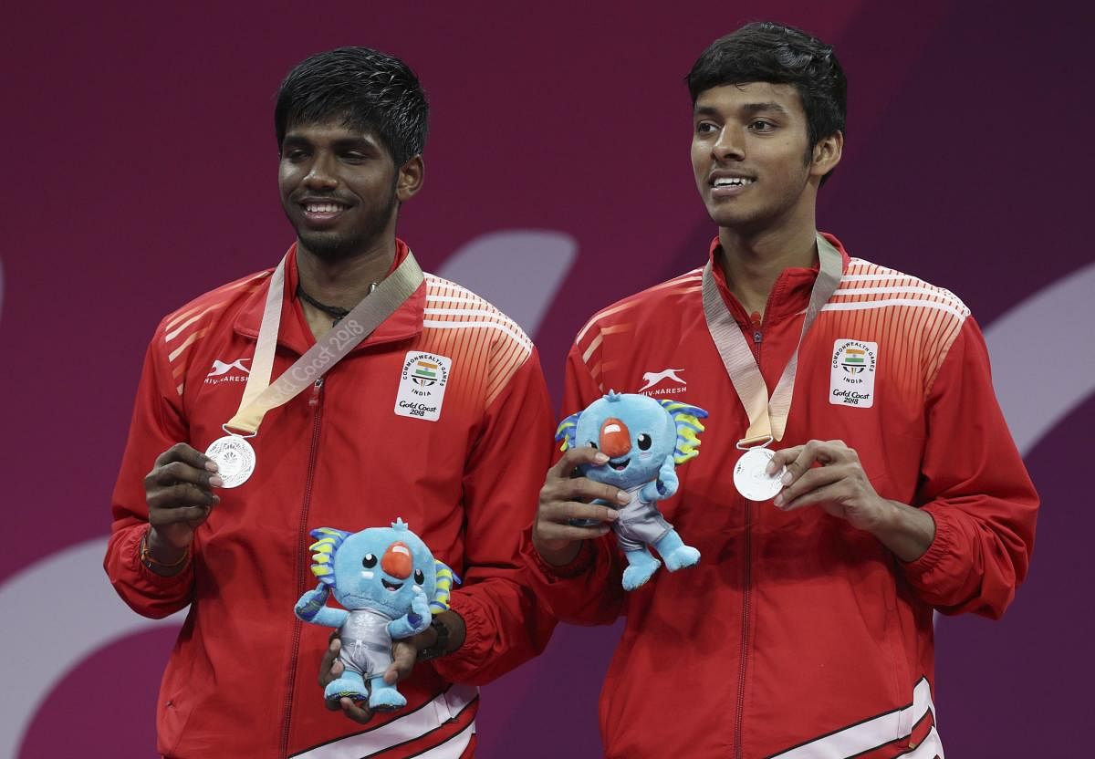 Silver medallists Satwik Rankireddy and Chirag Chandrashekhar Shetty of India pose with their medals and Borobi plush dolls during the medal ceremony. REUTERS.