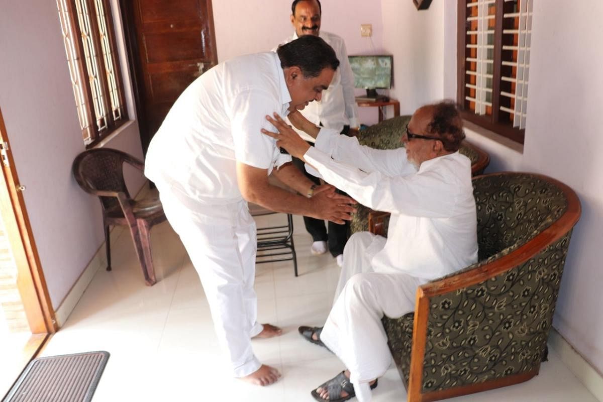 Congress candidate from Bantwal Assembly constituency and District-in-Charge Minister B Ramanath Rai receiving the blessing of former union minister Janardhan Poojary, at Poojary's house in Bantwal on Wednesday.