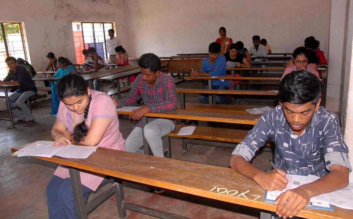 Students write CET exam at Government PU College, Bellor Road, in Chikkamagaluru on Wednesday.