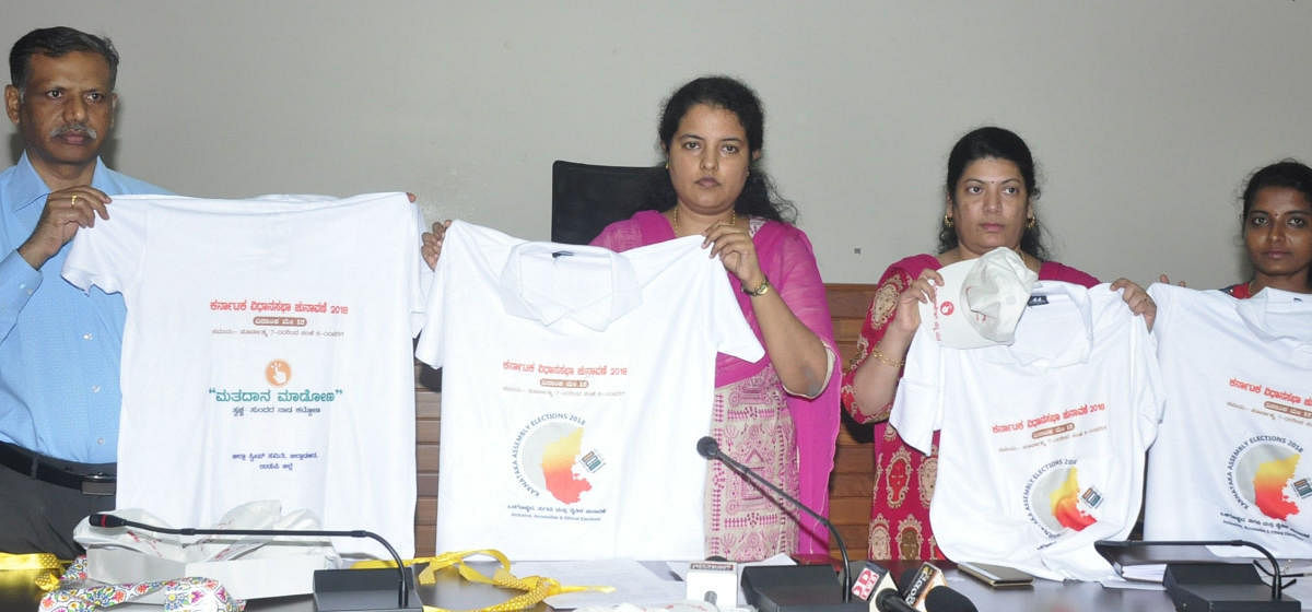 Udupi Deputy Commissioner Priyanka Mary Francis releasing T-shirts as a part of creating awareness on the importance of elections, in Udupi on Wednesday. DH photo