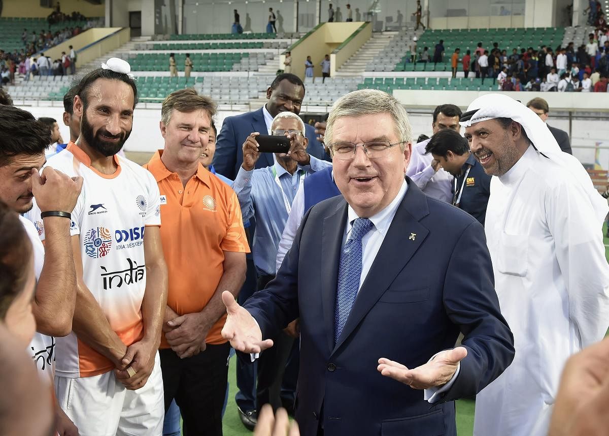 International Olympic Committee President Thomas Bach interacts with the Indian hockey players during a mixed team match at the Dhyan Chand National Stadium in New Delhi on Thursday. PTI