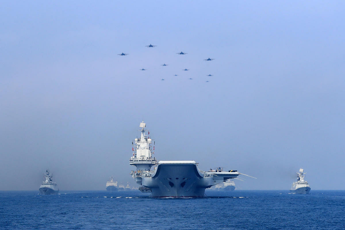 Chinese warships and jets on the South China Sea. Reuters file photo.