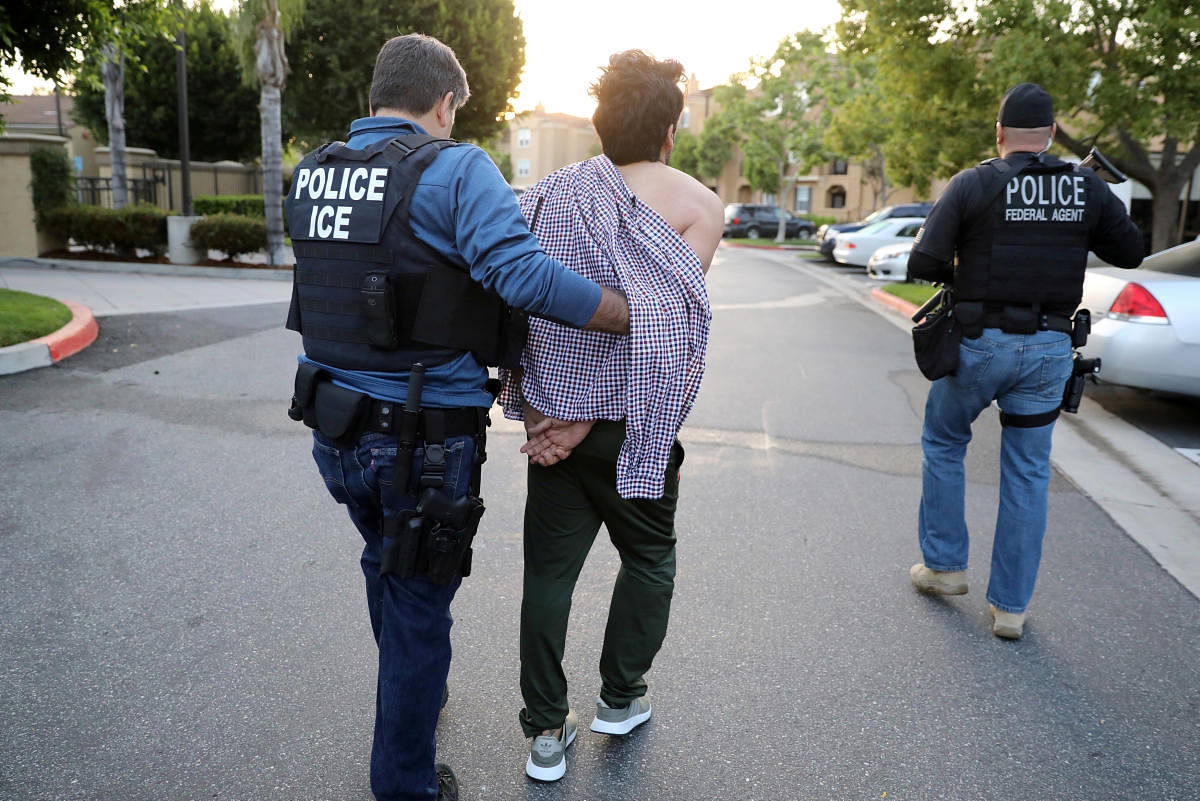 U.S. Immigration and Customs Enforcement (ICE) Assistant Field Office Director Jorge Field (L), 53, arrests an Iranian immigrant in San Clemente, California, U.S., May 11, 2017. 