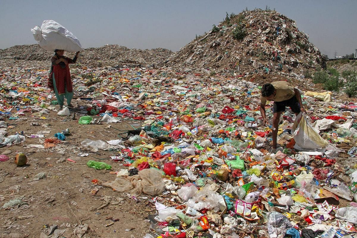 A rag-pickers collect reusable material from a garbage dumping site on the outskirts of Jammu on Sunday. This year's Earth Day theme focuses on 'Ending Plastic Pollution'. It is devoted to contribute information and inspire to change human attitude and behaviour about plastics. PTI Photo