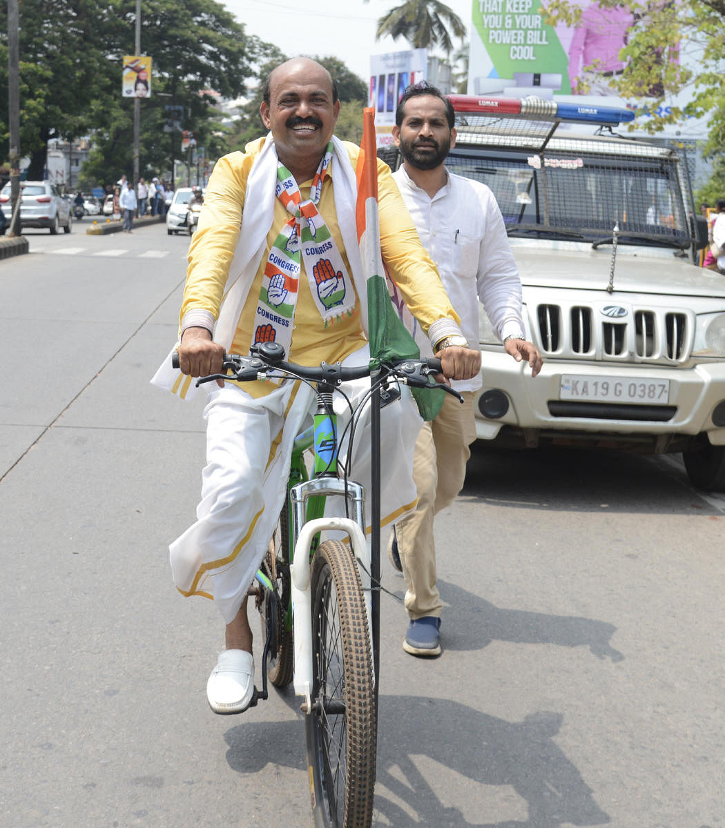 with pics7MLA and Congress candidate from Mangaluru City North constituency Mohiuddin Bava arrives in bicycle for filing the nomination papers, in Mangaluru on Monday.