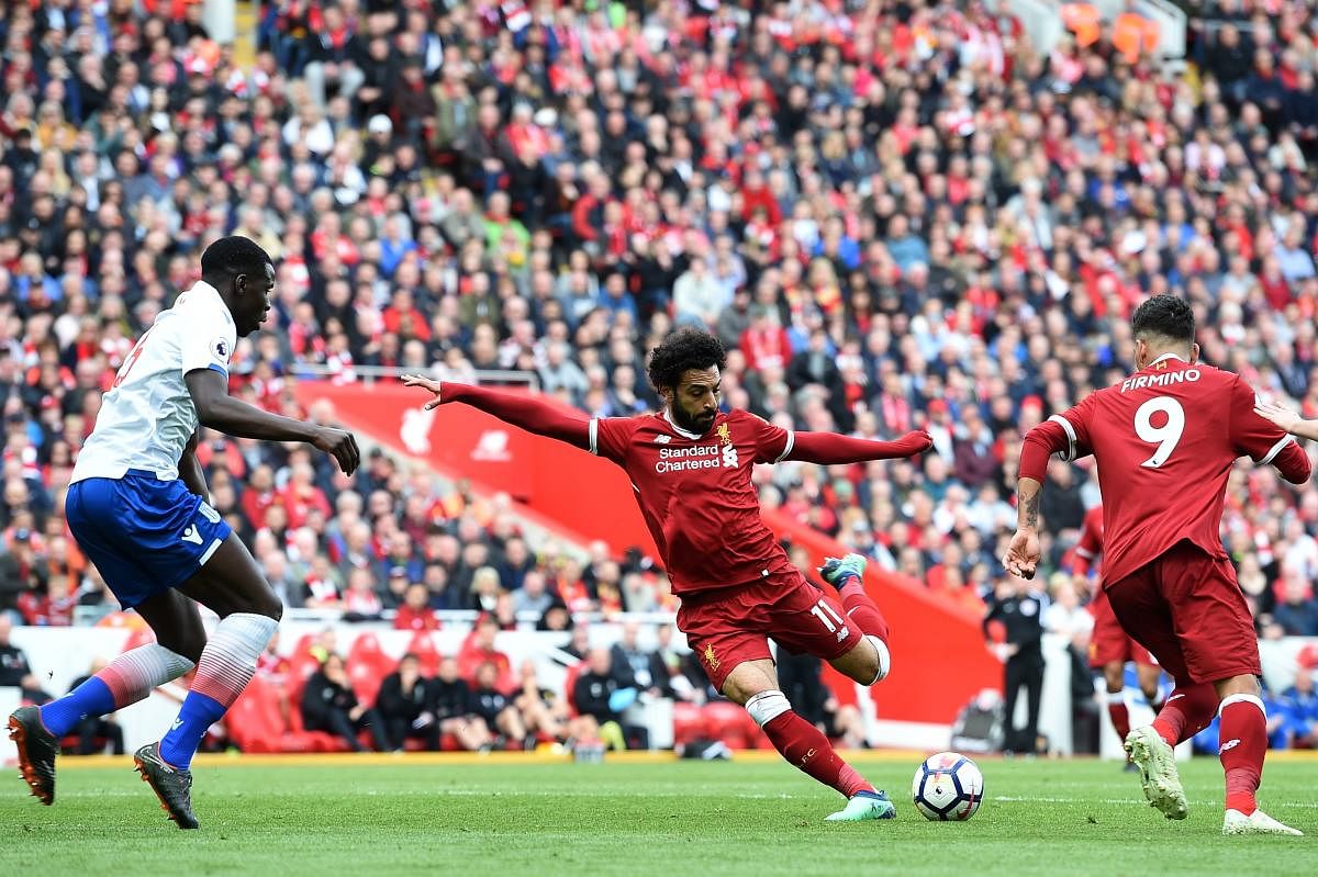 Liverpool's Mohamed Salah takes a shot as Kurt Zouma (left) of Stoke City looks on Saturday. AFP