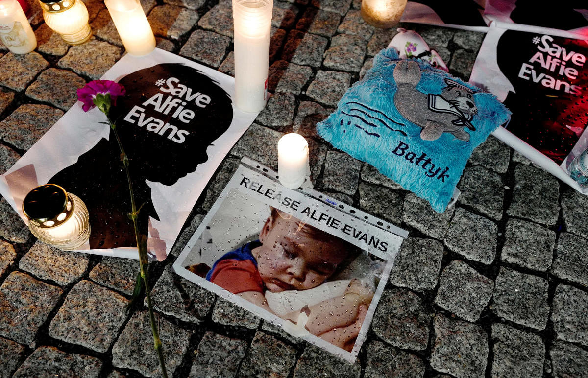 Candles and placards are pictured during a protest in support of Alfie Evans, in front of the British Embassy building in Warsaw, Poland. Reuters Photo