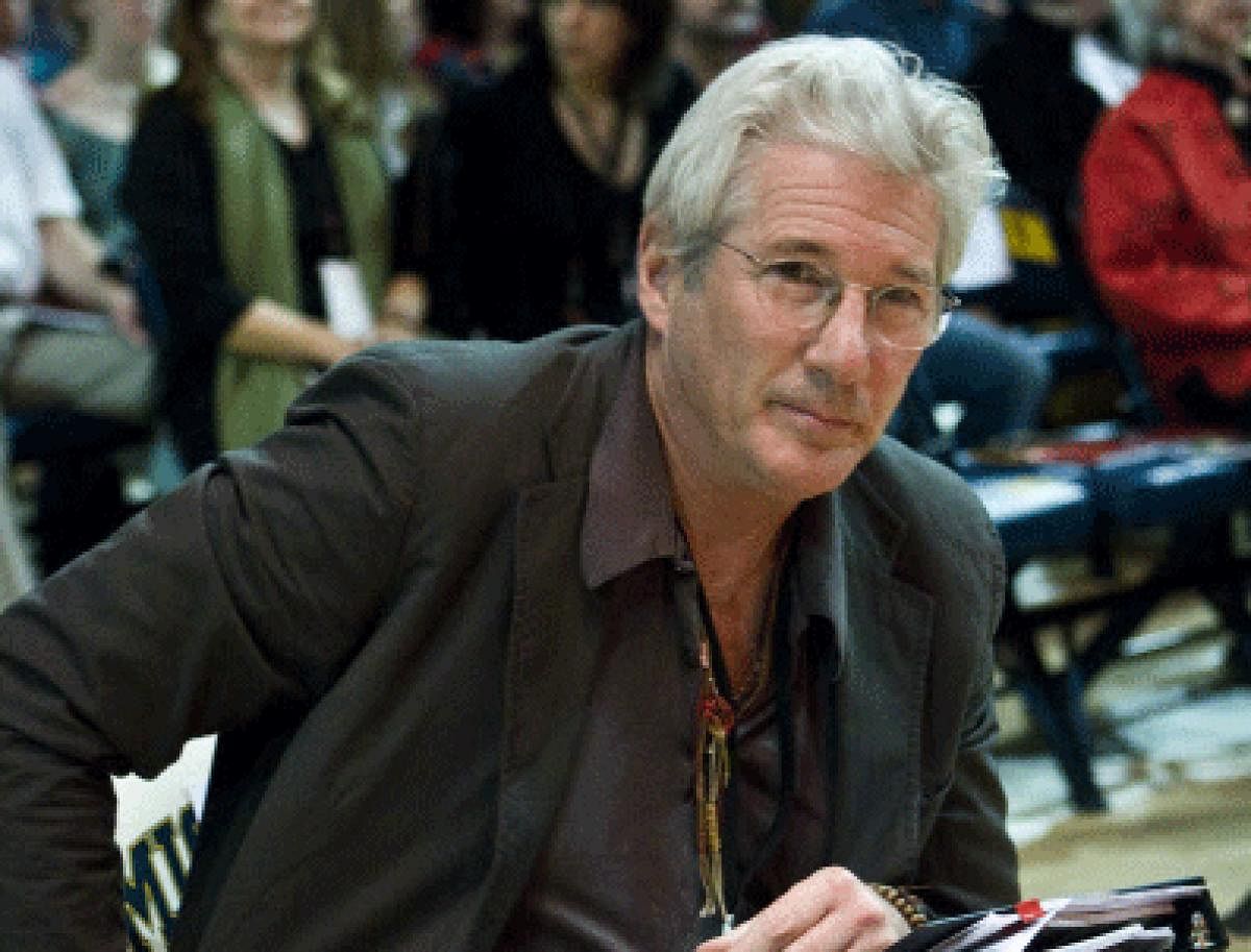Richard Gere has filed a lawsuit alleging extortion of USD 500, 000 over the film rights to a book on Buddhism. AP file photo