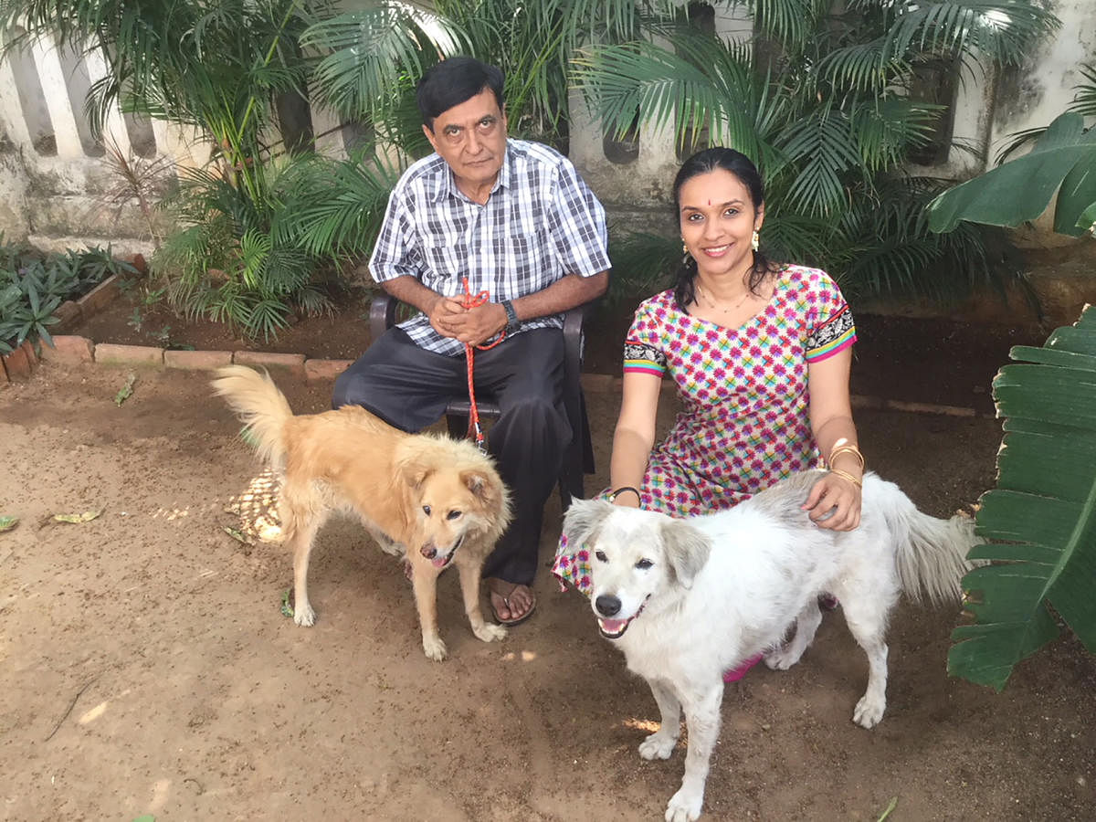 The author Madhu (right) with uncle Vijay and pets Foxy and Friendly.