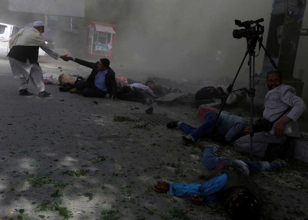 Afghan journalists are seen after a second blast in Kabul, Afghanistan. REUTERS Photo