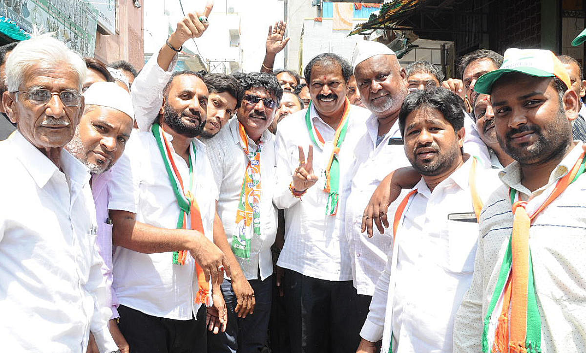 Congress candidate Akhanda Srinivasa Murty with his supporters at D G Halli ward in Bengaluru on Saturday.