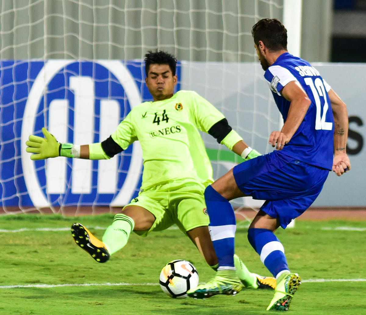 BFC's Daniel Segovia (right) tries to score past Aizawl FC goalkeeper Lalawmpuia during their clash in the AFC Cup football tournament at the Sree Kanteerava Stadium in Bengaluru on Wednesday. (DH Photo/B H Shivakumar)