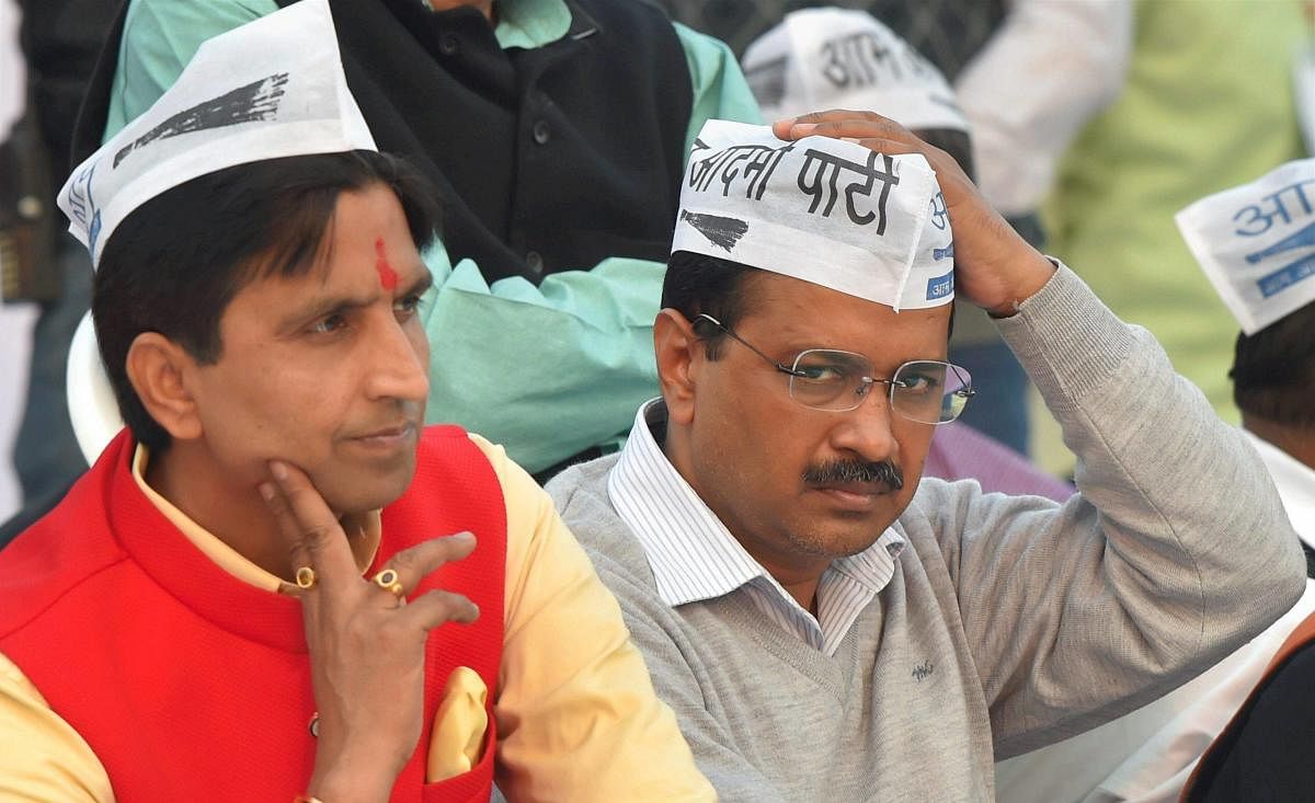 AP convenor and Delhi Chief Minister Arvind Kejriwal with party leader Kumar Vishwas during a convention to mark the party's 5th Foundation Day at Ramlila Maidan in New Delhi on Sunday. PTI File Photo
