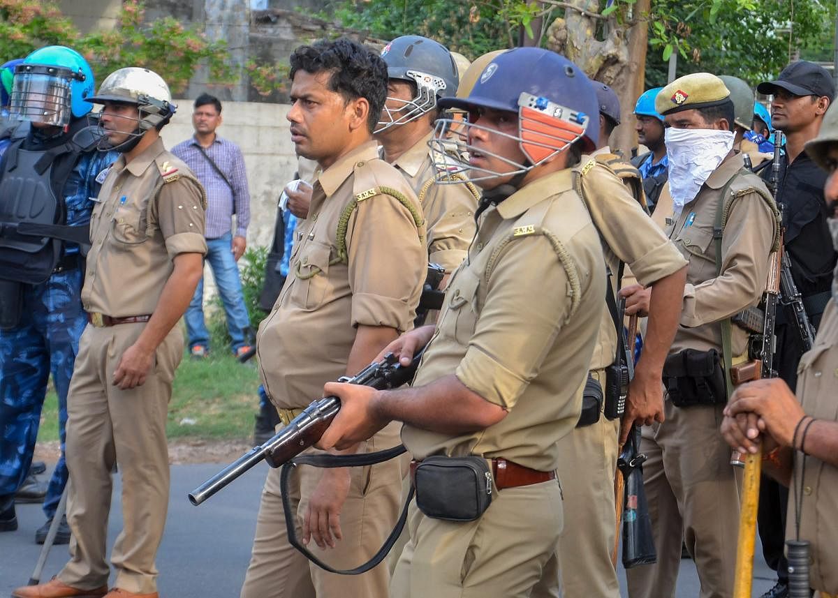 Uttar Pradesh Police personnel deployed outside university gate at Aligarh Muslim University in Aligarh. PTI Photo
