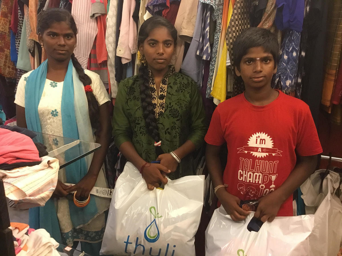 Malathi, Arulmozhi and Balaji, all from lower income class, shop at Thuli in Chennai.