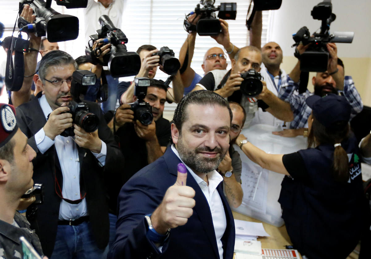 Lebanese prime minister and candidate for the parliamentary election Saad al-Hariri shows his ink-stained finger after casting his vote in Beirut, Lebanon. REUTERS