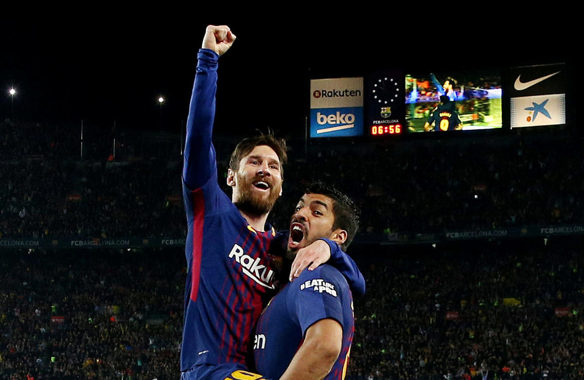 Barcelona's Lionel Messi celebrates scoring their second goal with Luis Suarez. Reuters.