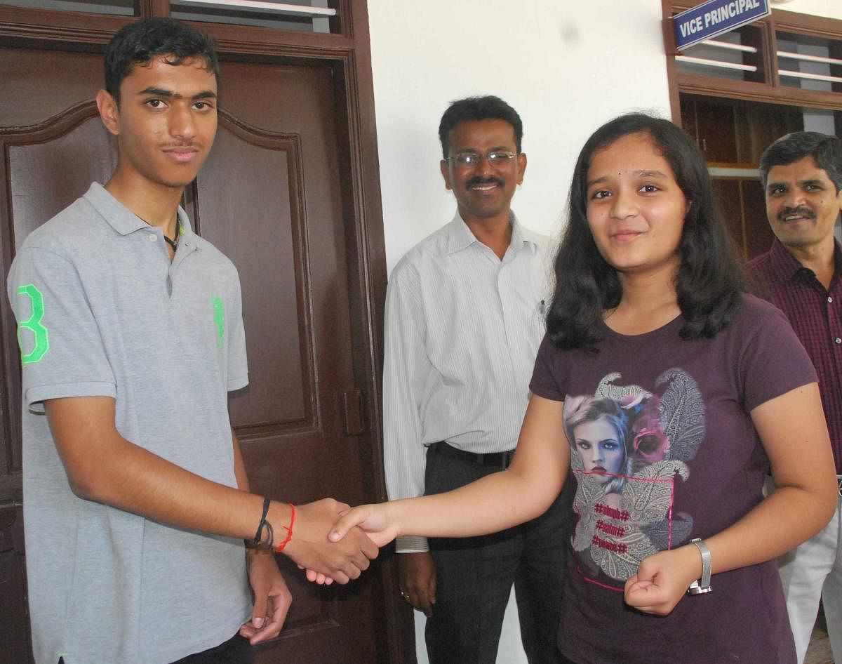 B Hima and Kaveriappa of Vijaya English Medium school, greet each other in Hassan on Monday. dh photo
