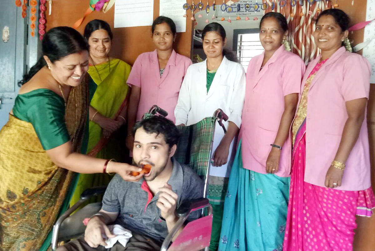 Endosulfan victim Abhishek B V celebrating SSLC result with his mother Gangarathna at Endosulfan Day Care Centre in Koila on Monday.