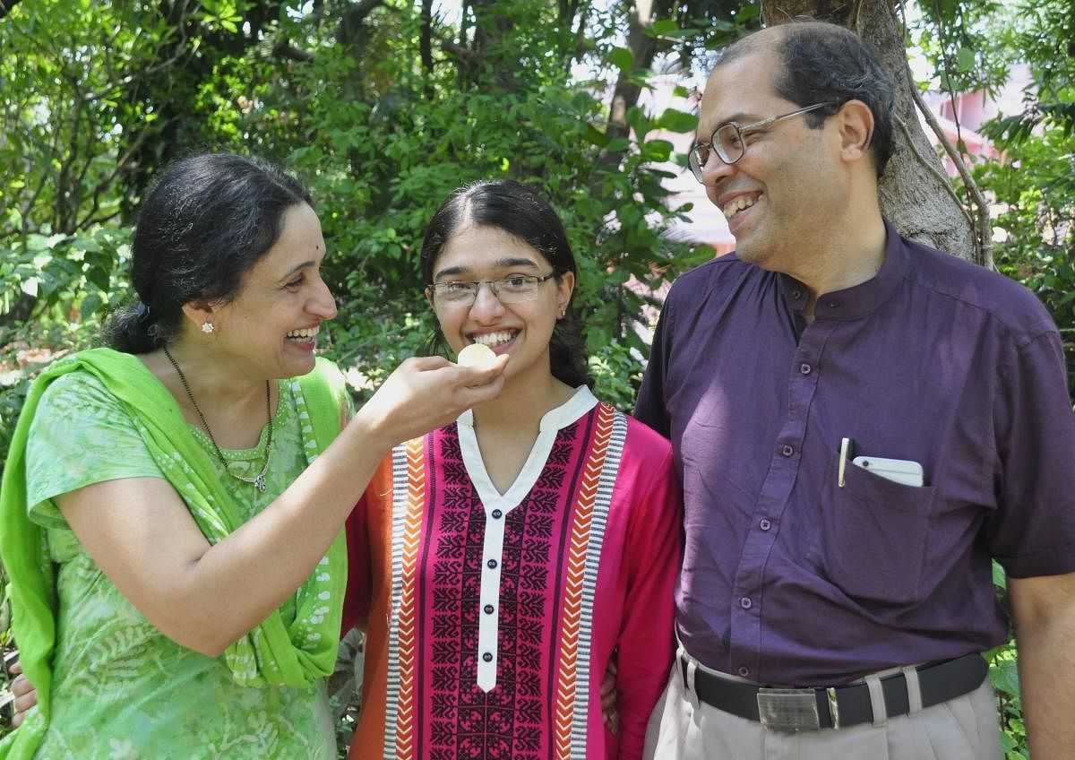Medha top scorer in Udupi district celebrating her success with her parents Shashikala Bhat and Dr Narasimha Bhat.