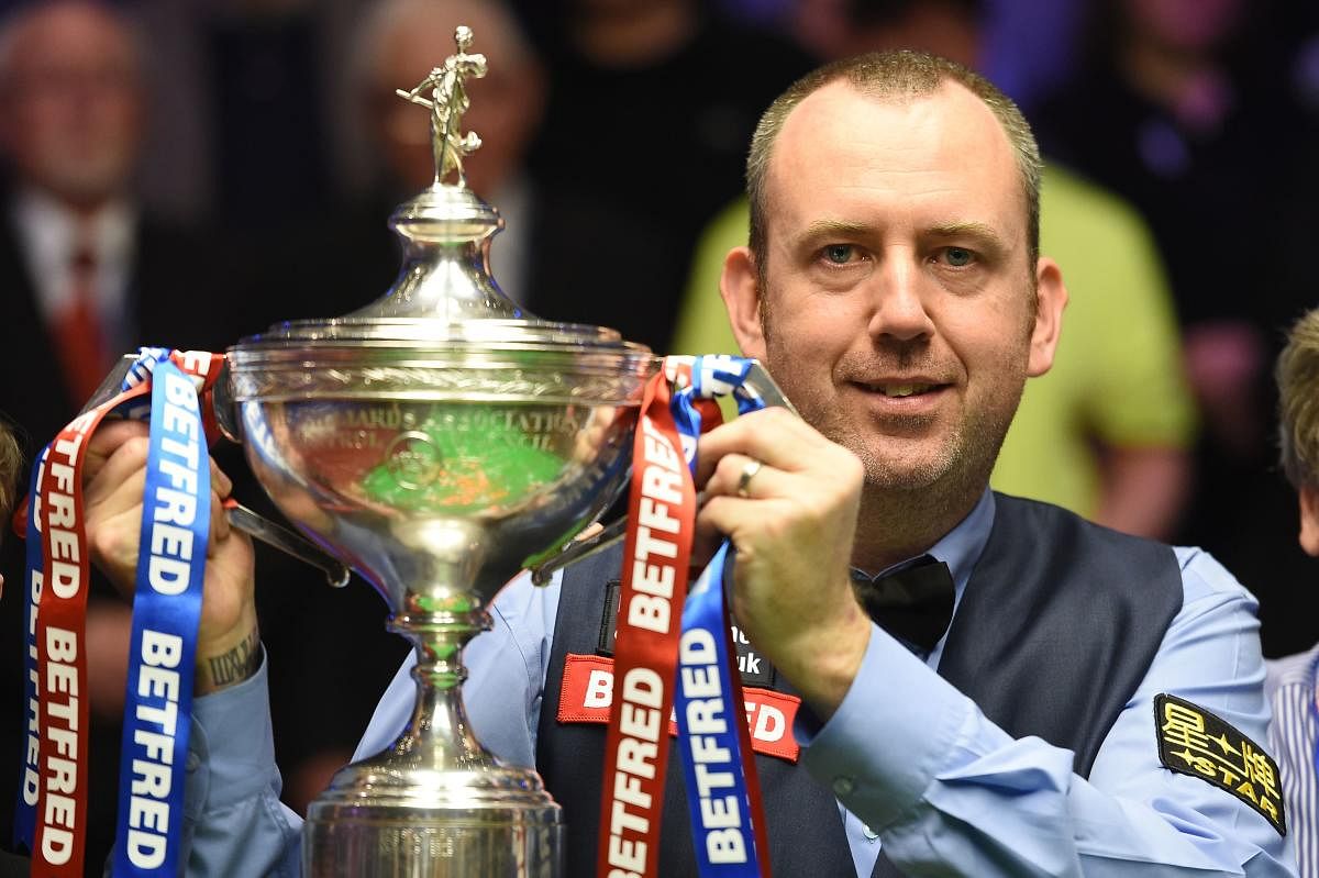 Wales's Mark Williams celebrates with the trophy after beating Scotland's John Higgins in the World Championship Snooker final in Sheffield, England, on Monday. AFP