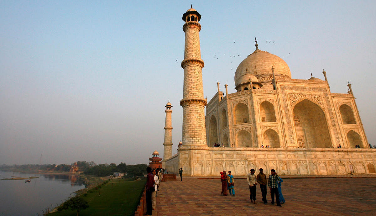Tourists walk in front of the historic Taj Mahal, Agra. REUTERS Photo
