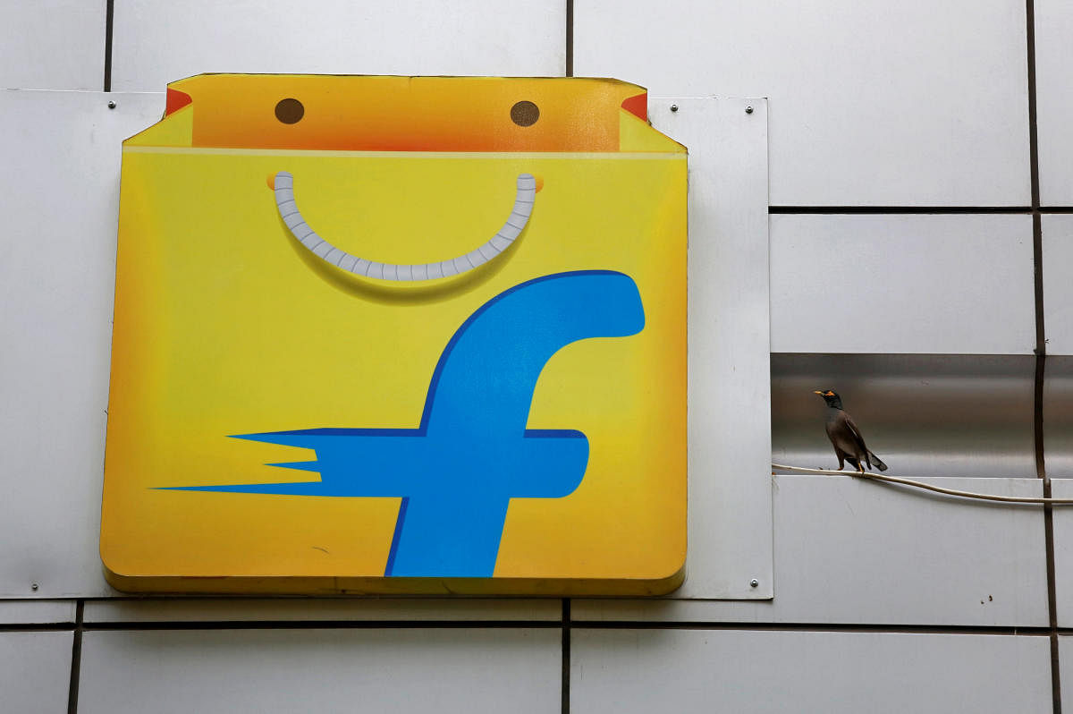 FILE PHOTO: A Common myna sits next to the logo of India's ecommerce firm Flipkart installed on the company's office in Bengaluru. Reuters