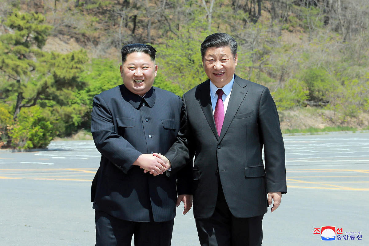 North Korean leader Kim Jong Un shakes hands with China's President Xi Jinping, in Dalian, China. Reuters Photo