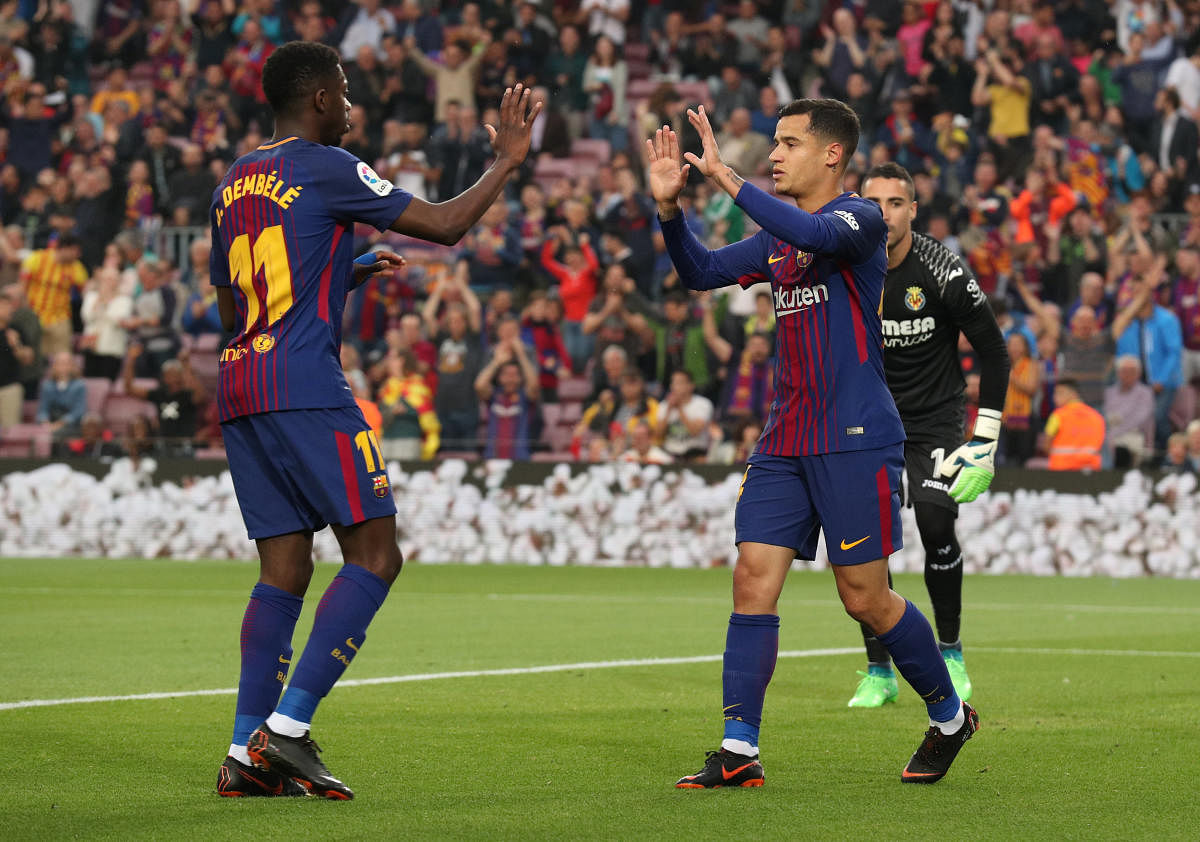 Barcelona's Philippe Coutinho celebrates with team-mate Ousmane Dembele after scoring against Villarreal on Wednesday. REUTERS