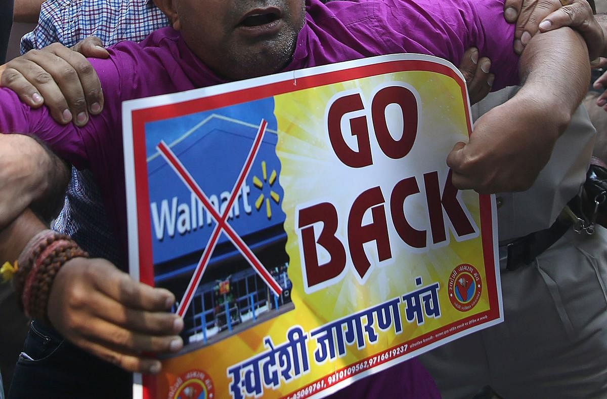 Protesters hold a placard against Walmart in New Delhi on Thursday. 