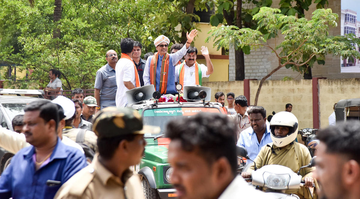 BJP candidate of KR Assembly Constituency S A Ramadas along with Madhya Pradesh CM Shivraj Singh Chouhan, MP Pratap Simha and others taking part in road show during campaigning, at Vidyaranyapura in Mysuru on Wednesday. -Photo by Savitha. B R