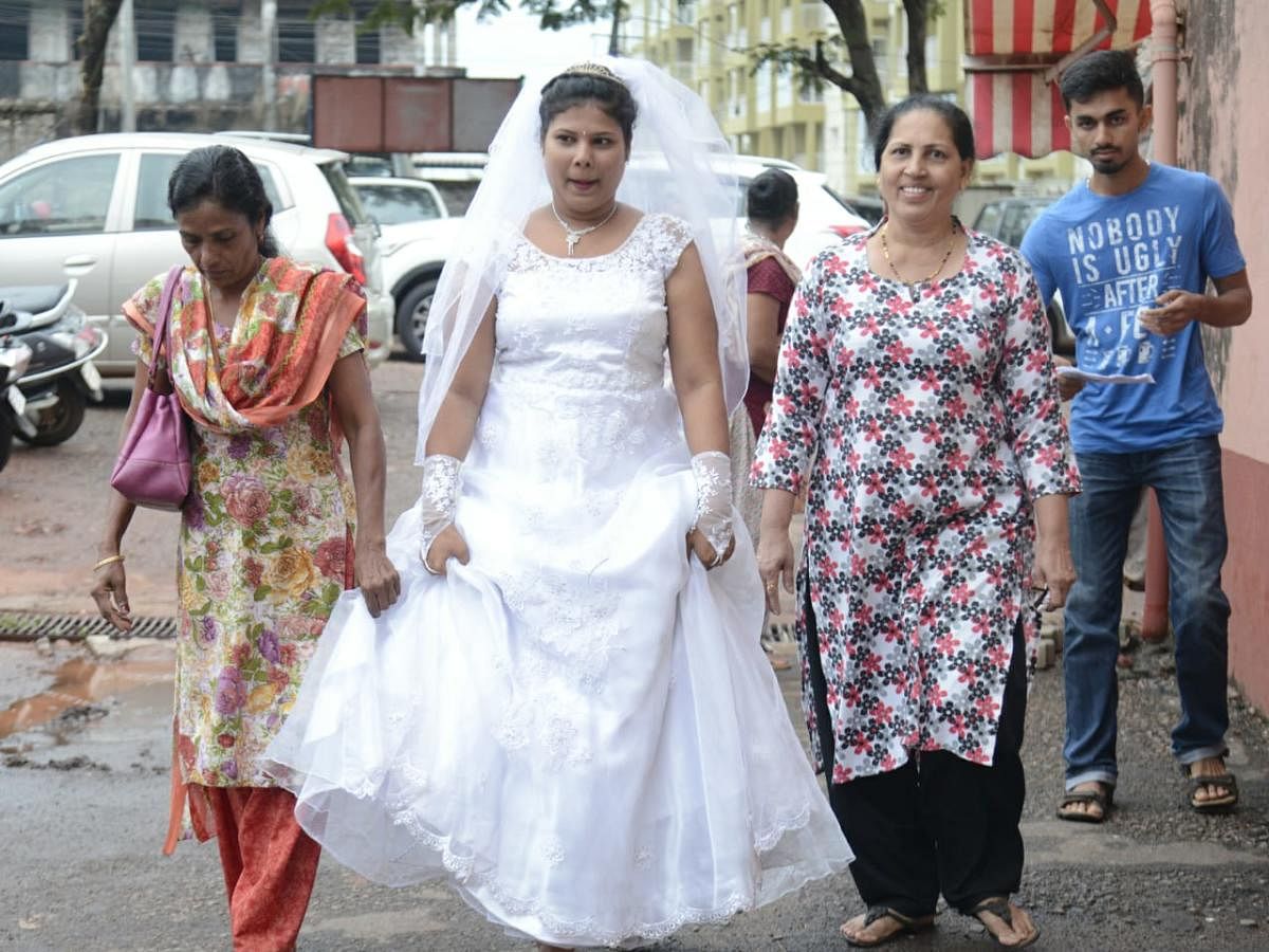 Newly-wed bride Viola Maria Fernandes comes to cast her vote at the Saint Lawrence English School at Bondel in Mangaluru on Saturday.