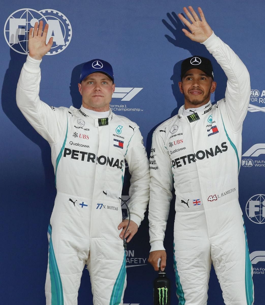 RIGHT START: Mercedes' Lewis Hamilton and team-mate Valtteri Bottas acknowledges the crowd after the qualifying session at the Barcelona Catalunya circuit in Spain on Saturday. AP/PTI