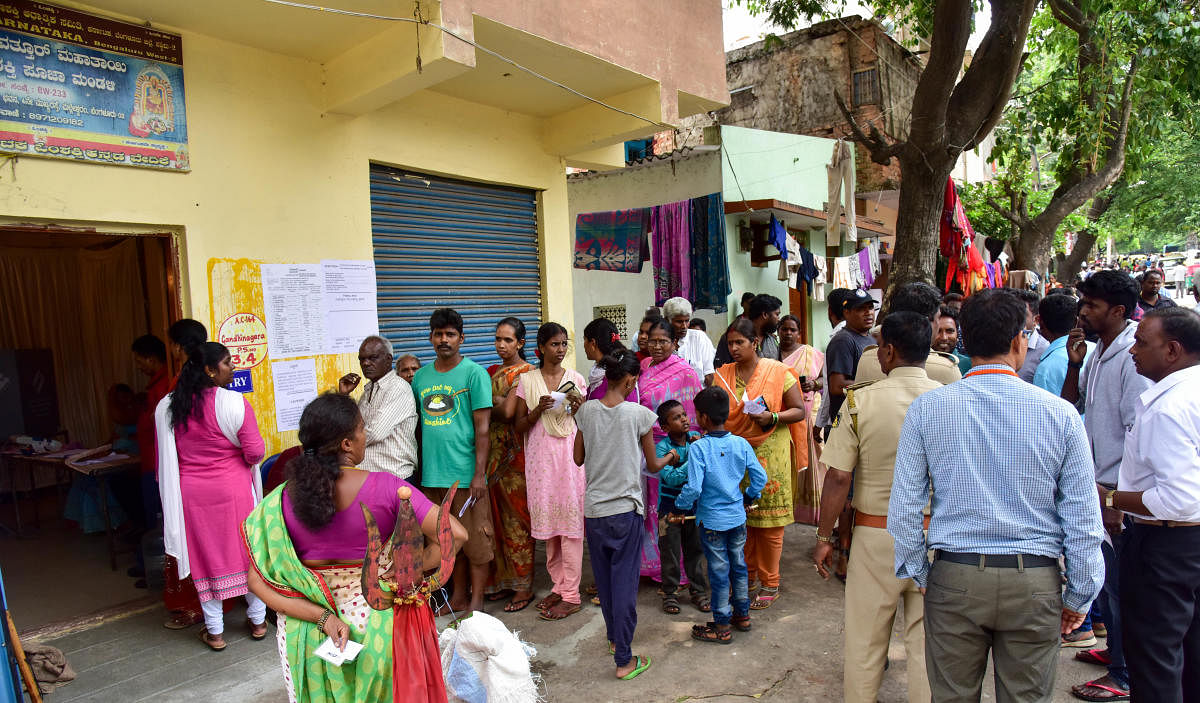 Voters are halted polling for a brief period, more than a hour due to mechanical problems in BR Ambedkar Social Welfare Association office in Valluvarapuram booth, Gandhinagar Constituency, in Bengaluru on Saturday 12th May 2018. DH Photo