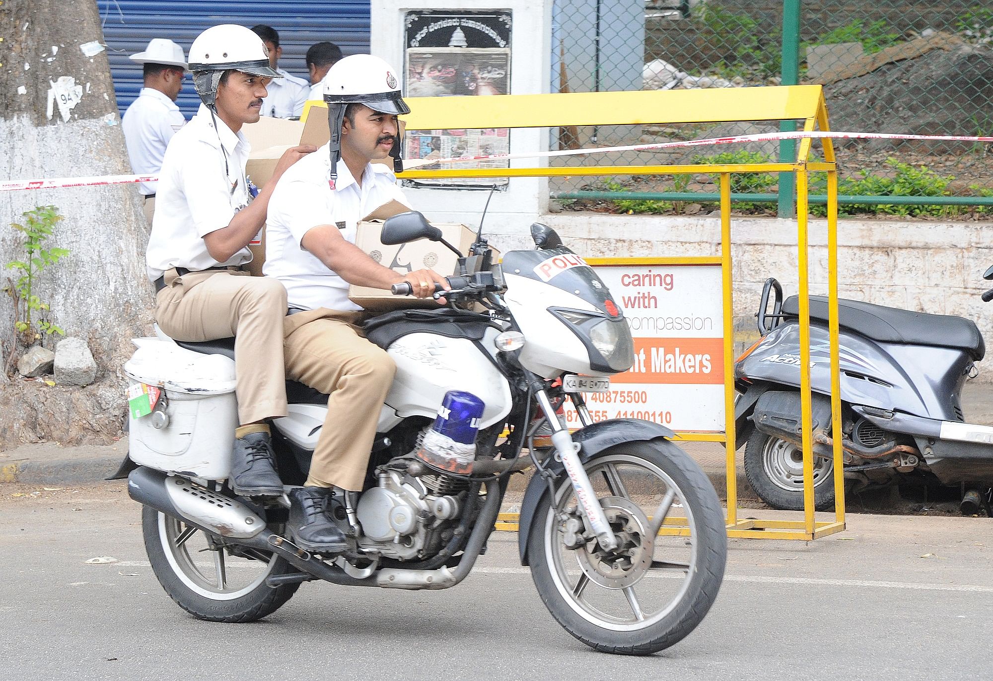Not strapping helmets or improper use of helmets is a common sight in the city, even among police officials. DH PHOTO BY SRIKANTA SHARMA R