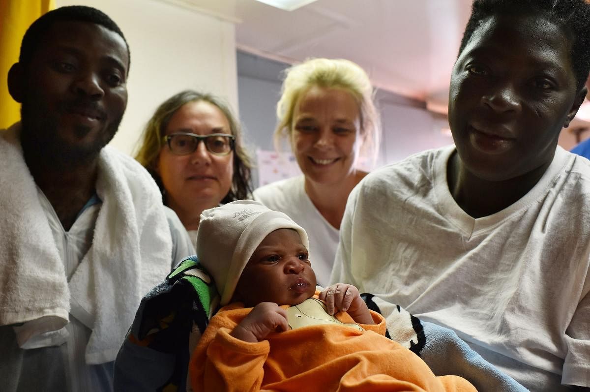 Bernadette Obiona and David Dibonde (L) with their newborn baby. AFP