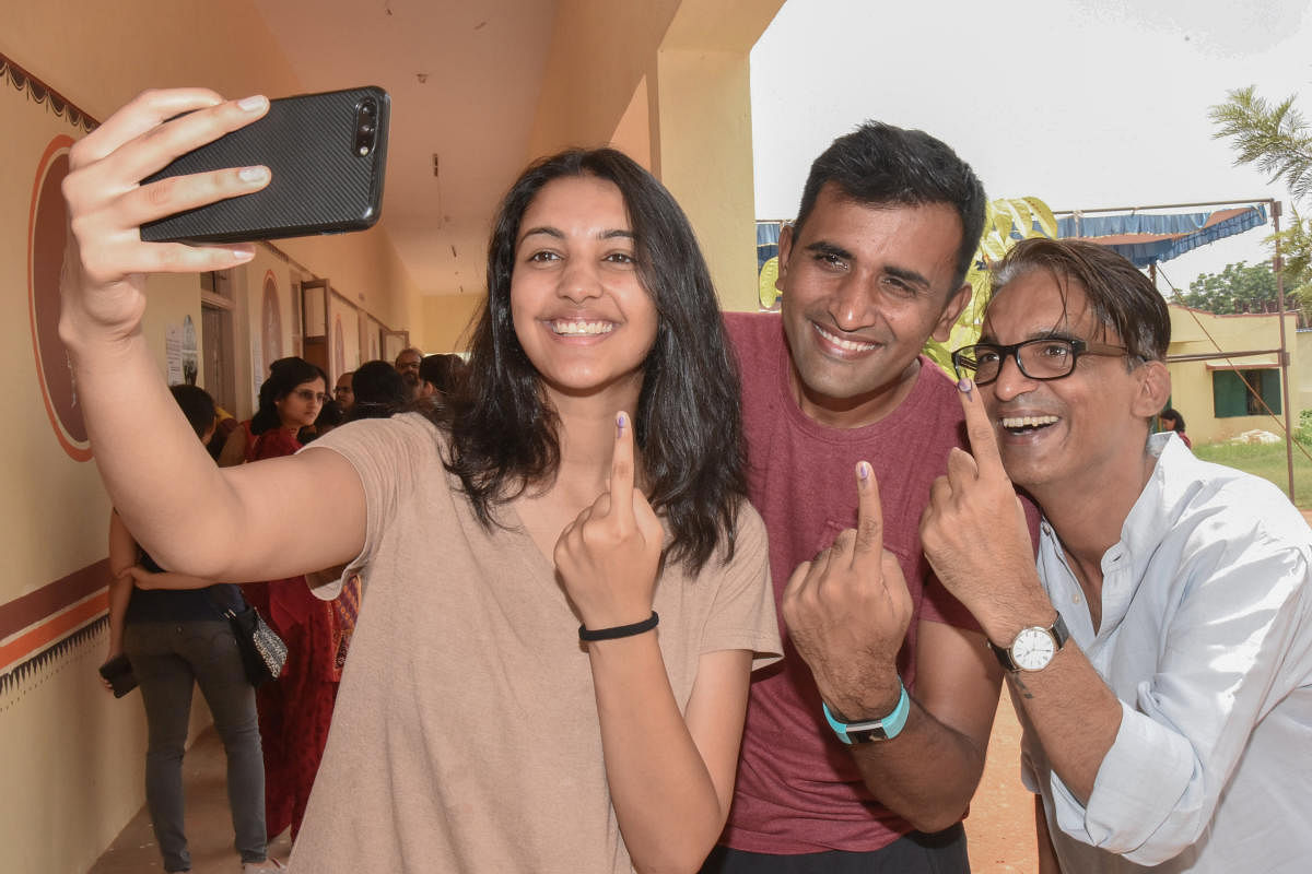 Family members taking selfie after cast vote at Mahadevapura legislative assembly constituency election at Government Higher Primary School at Hoodi in Bengaluru on Saturday. Photo by S K Dinesh