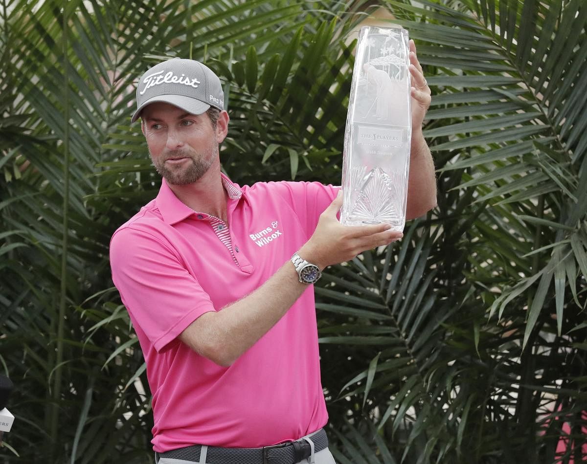 Webb Simpson celebrates with THE PLAYERS Championship trophy after triumphing on Sunday. AP/ PTI
