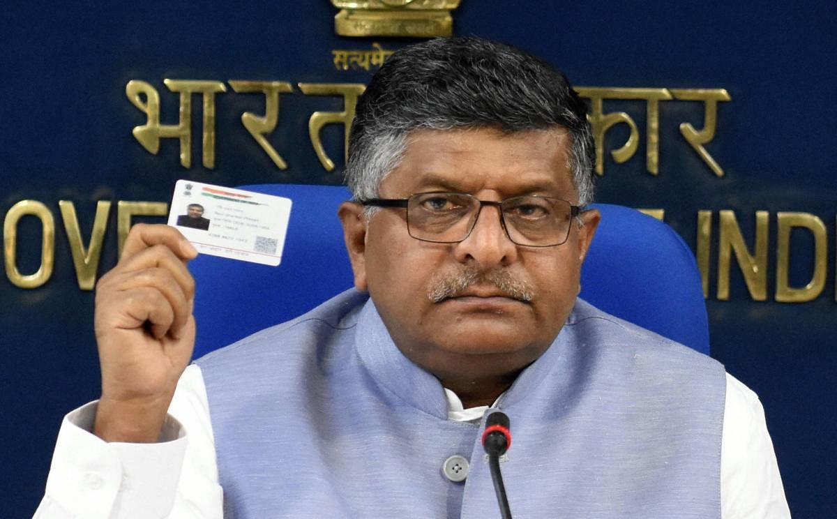 Jitendra Singh's assertion assumes significance as there were reports of some retired employees facing difficulty in getting pension as their bank accounts were not linked with Aadhaar. (Representational image shows Union Law Minister Ravi Shankar Prasad holding his Aadhaar card up)