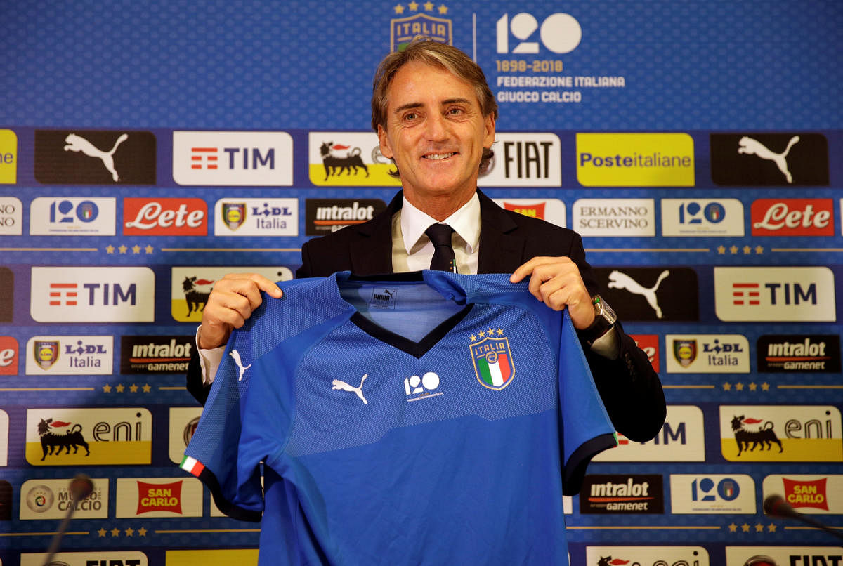 Roberto Mancini is all smiles after being unveiled as the new Italy coach on Tuesday. REUTERS