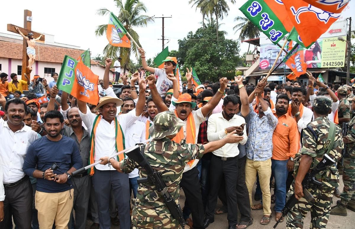 BJP workers rejoice outside the counting centre in Mangaluru to celebrate the sweeping victory of the party in DK on Tuesday.