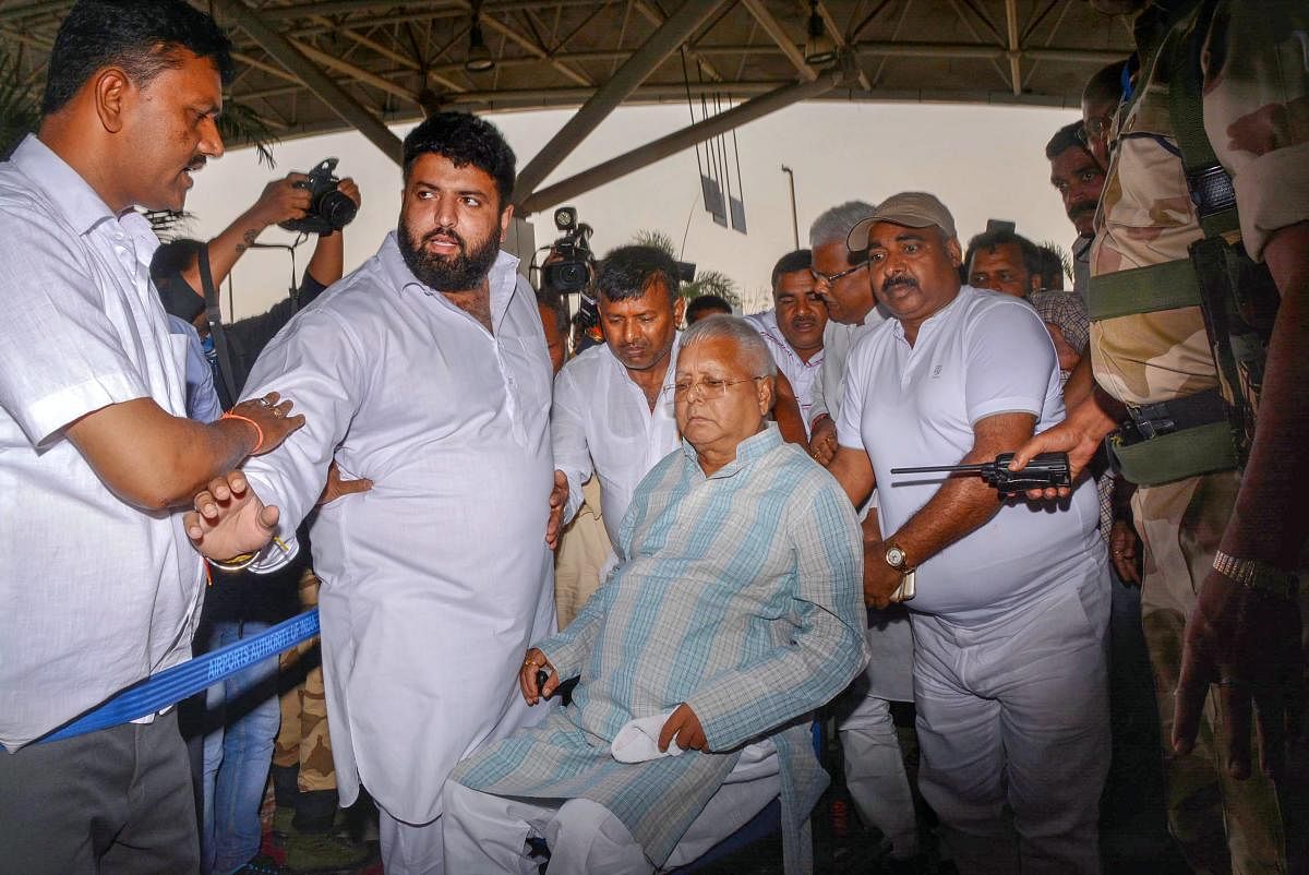 RJD Chief Lalu Prasad Yadav, after being granted bail for six weeks, arrives at Birsa Munda International Airport, in Ranchi, on Wednesday. PTI
