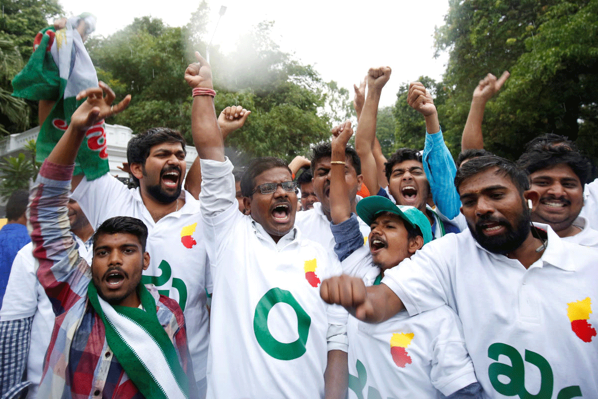 Supporters of Janata Dal (Secular) celebrate outside the governor's house in Bengaluru, India, May 15, 2018. REUTERS