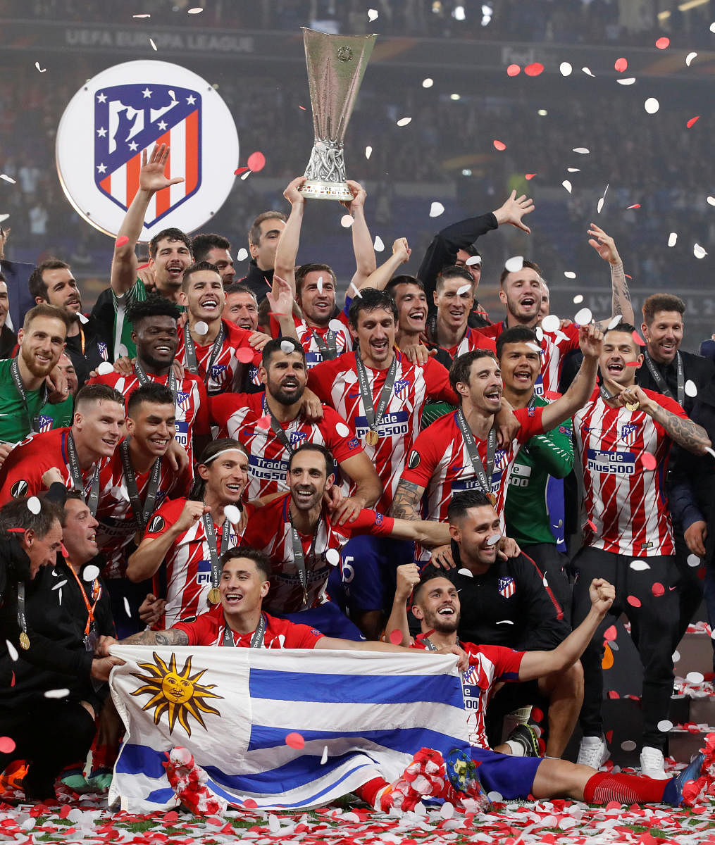 Champions: Atletico Madrid players celebrate with the Europa League trophy after beating Marseille 3-0 in the final. Reuters