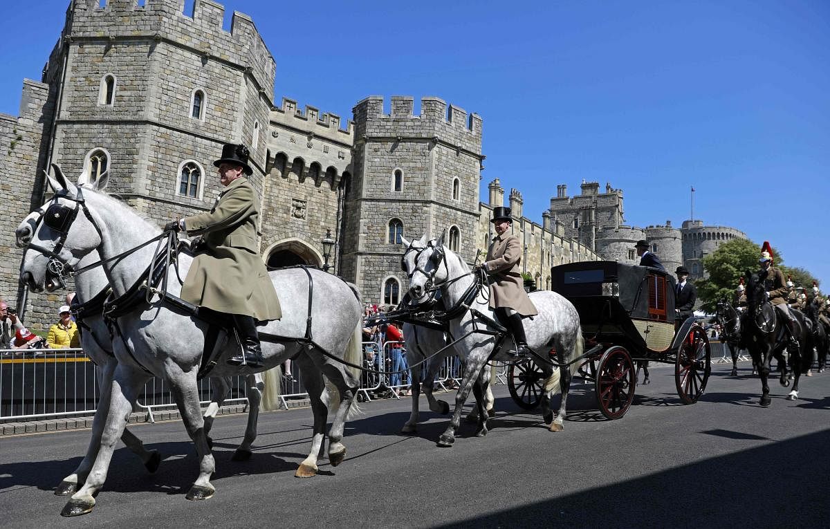 The Ascot Landau carriage pulled by Windsor Grey horses, is taken past the Henry VIII gate during a rehearsal for the wedding procession outside Windsor Castle in Windsor on Thursday. Britain's Prince Harry and US actor Meghan Markle will marry on Saturda