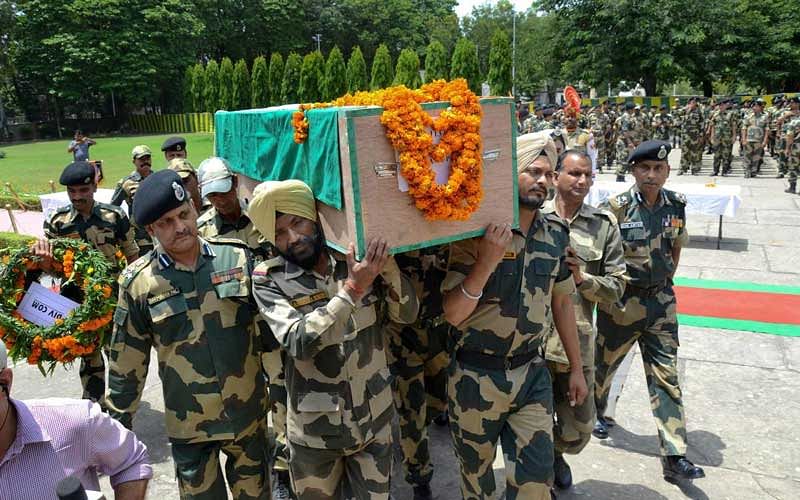 Border Security Force officers and jawans carry the coffin of Sitaram Upadhyay during his wreath-laying ceremony, at BSF HQ Campus Paloura, in Jammu, on Friday. Upadhyay was killed in ceasefire violation by Pakistani army along the international border. PTI